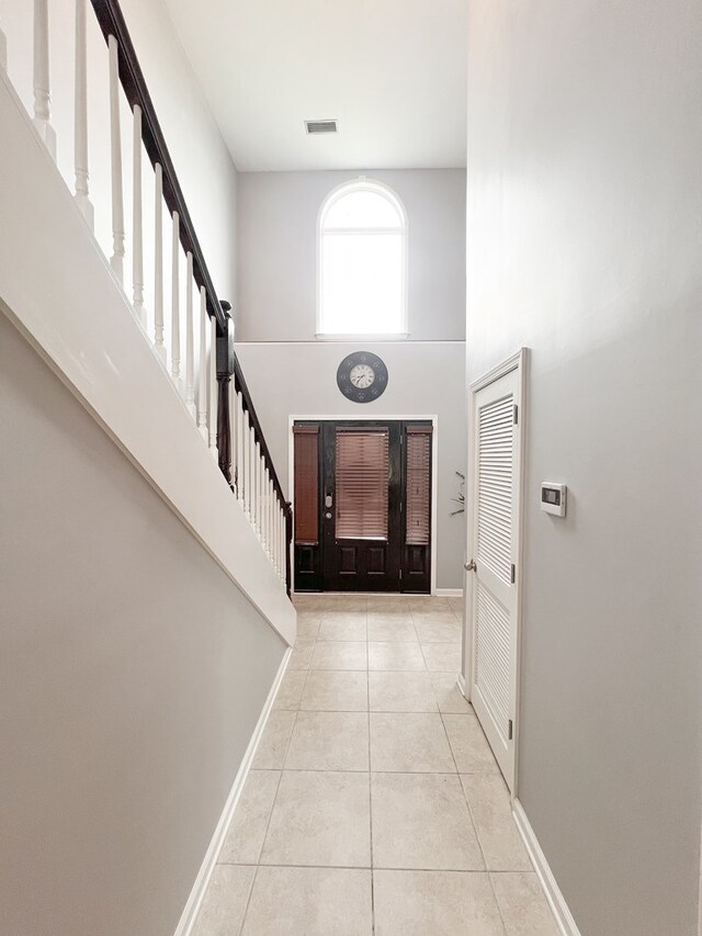 305 Millenia St, Enterprise, AL 36330 - tiled entryway featuring stairway, a towering ceiling, and baseboards