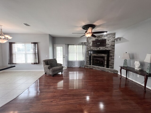 305 Millenia St, Enterprise, AL 36330 - living room featuring ceiling fan, wood finished floors, a fireplace, and a chandelier