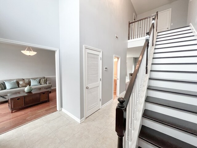 305 Millenia St, Enterprise, AL 36330 - stairs featuring a towering ceiling, tile patterned floors, and baseboards