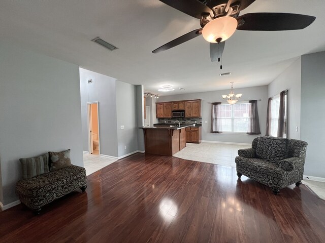 305 Millenia St, Enterprise, AL 36330 - living area with a chandelier, light wood-type flooring, baseboards, and a ceiling fan