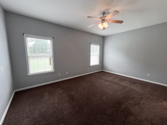 305 Millenia St, Enterprise, AL 36330 - spare room featuring baseboards, a ceiling fan, and dark colored carpet