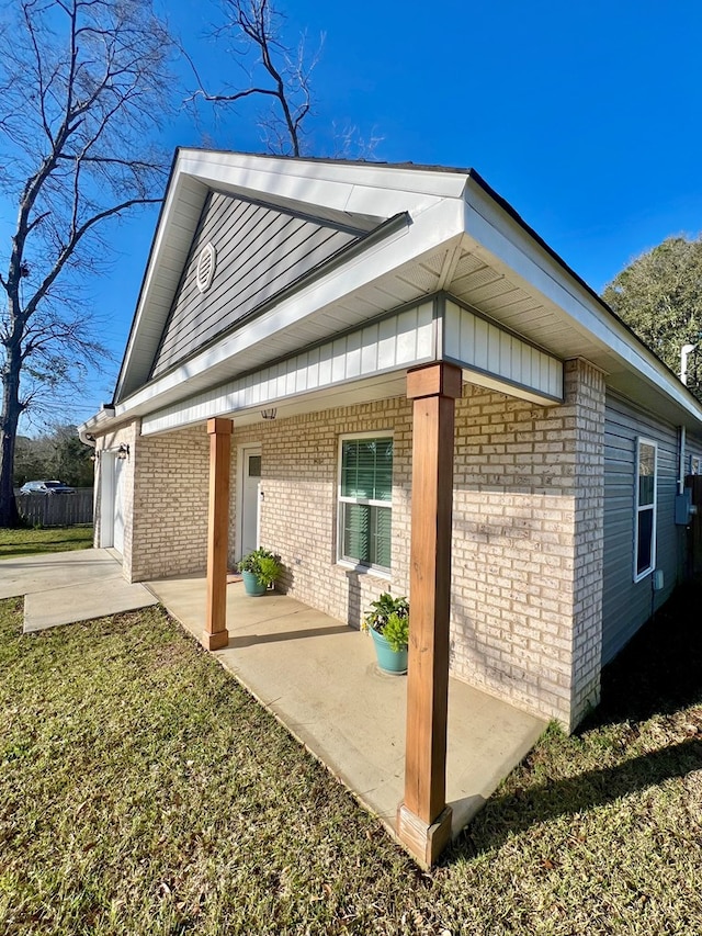 view of side of home with brick siding and board and batten siding