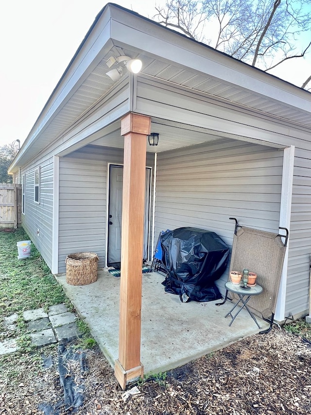 exterior space featuring an attached carport and fence