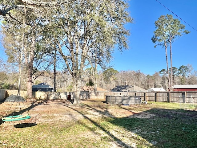 view of yard with a fenced in pool and a fenced backyard