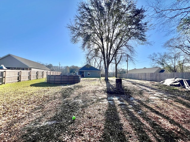 view of yard with a fenced in pool and a fenced backyard