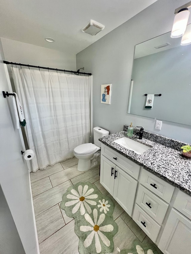 full bath with vanity, toilet, visible vents, and wood finish floors