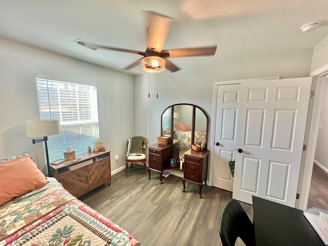 bedroom with a ceiling fan, light wood-style floors, and baseboards