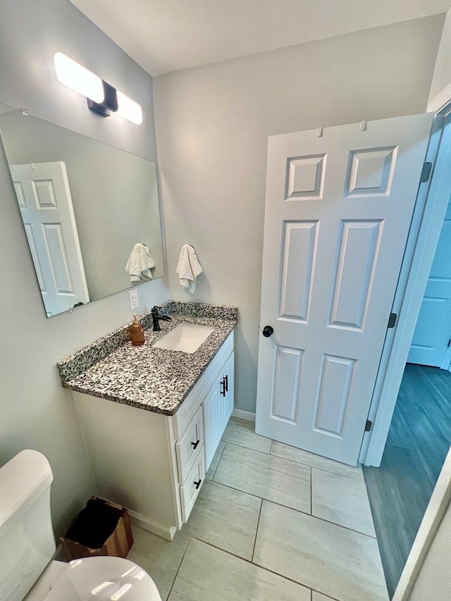 bathroom with toilet and vanity