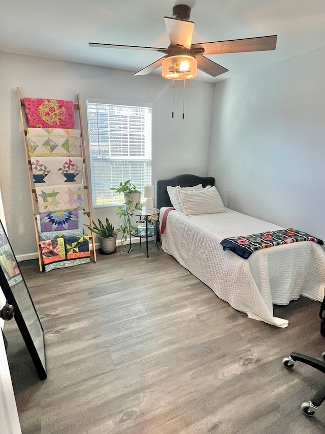 bedroom with wood finished floors and ceiling fan