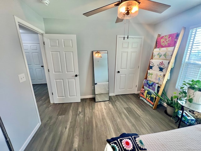 bedroom with ceiling fan, baseboards, and wood finished floors