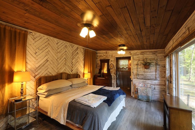 bedroom with access to outside, ceiling fan, wooden walls, wooden ceiling, and dark hardwood / wood-style floors