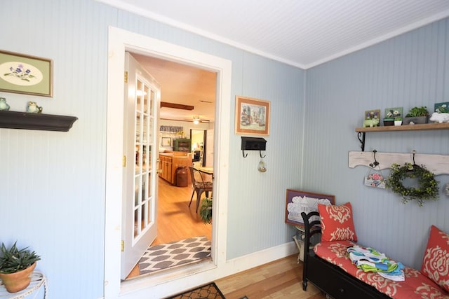 interior space with light hardwood / wood-style flooring and ornamental molding