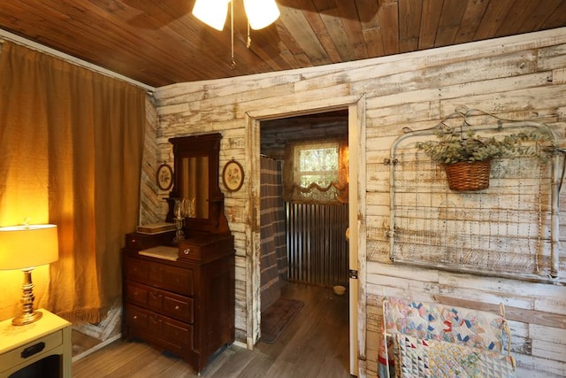 interior space with wood-type flooring, ceiling fan, and wooden ceiling