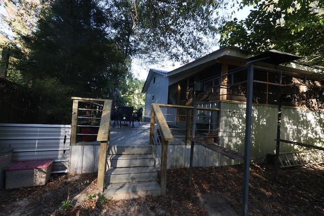 view of side of property with a wooden deck