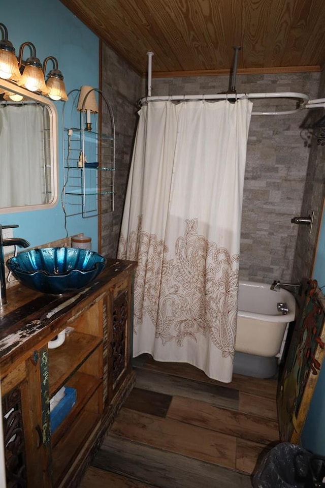 bathroom featuring shower / bath combination with curtain, hardwood / wood-style floors, vanity, and wooden ceiling