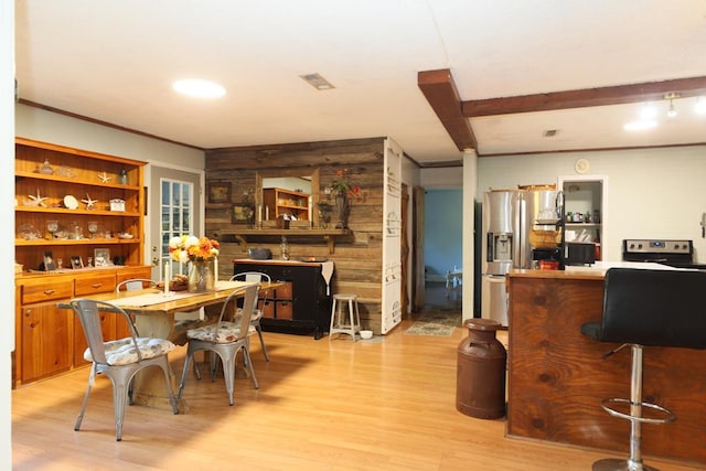 interior space with light wood-type flooring and wood walls