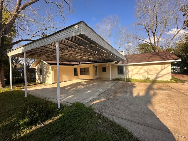 back of house featuring aphalt driveway
