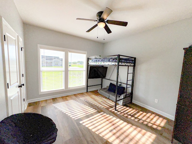 bedroom with baseboards and wood finished floors