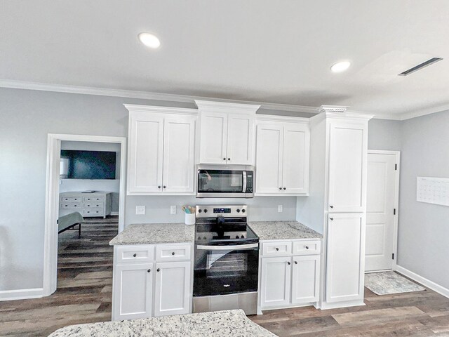 kitchen featuring white cabinets, visible vents, light wood-style flooring, and appliances with stainless steel finishes