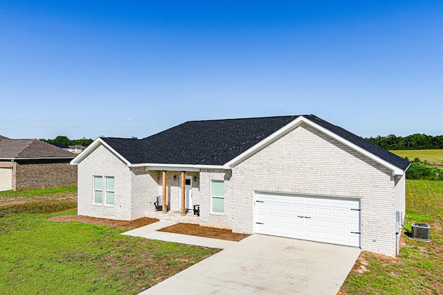 single story home featuring central air condition unit, driveway, an attached garage, a front yard, and brick siding