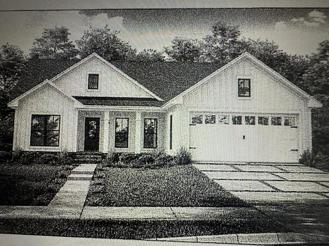 view of front facade featuring concrete driveway and an attached garage