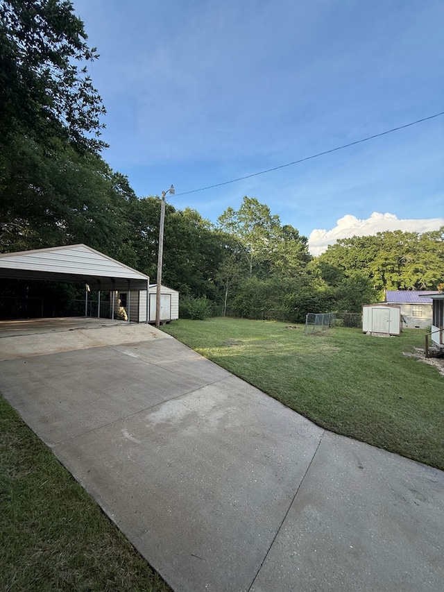 2303 Brown St, Dothan, AL 36303 - view of grassy yard featuring a carport and driveway