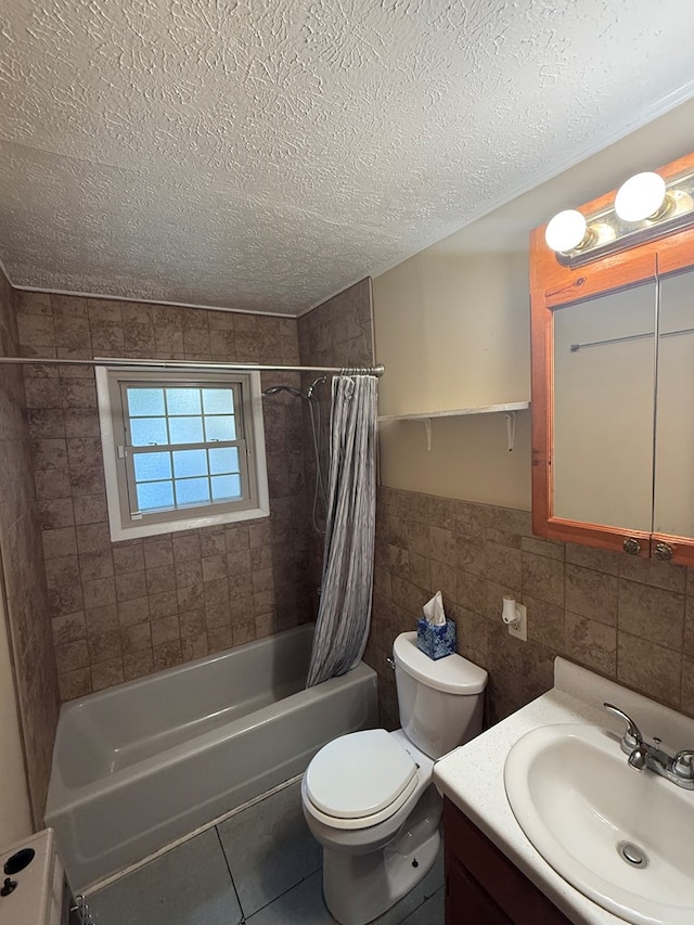 2303 Brown St, Dothan, AL 36303 - bathroom with a textured ceiling, tile walls, shower / tub combo, vanity, and toilet