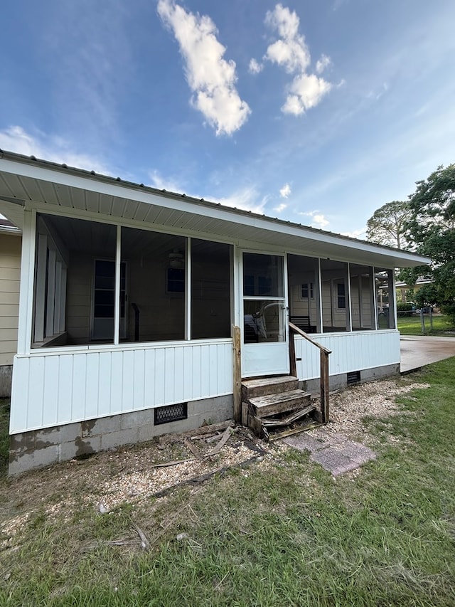 2303 Brown St, Dothan, AL 36303 - view of property exterior featuring crawl space, a sunroom, entry steps, and a lawn