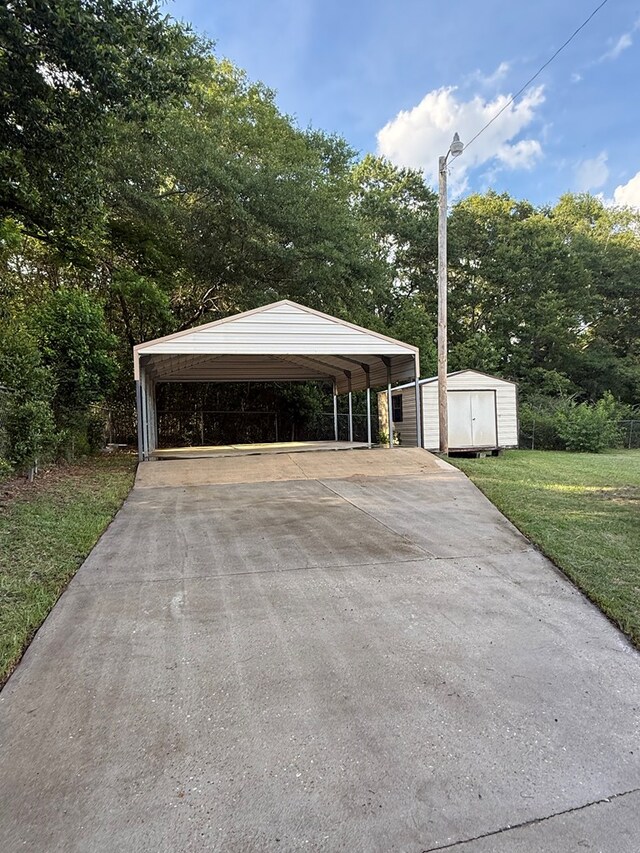 2303 Brown St, Dothan, AL 36303 - garage with a storage unit, a detached carport, and driveway
