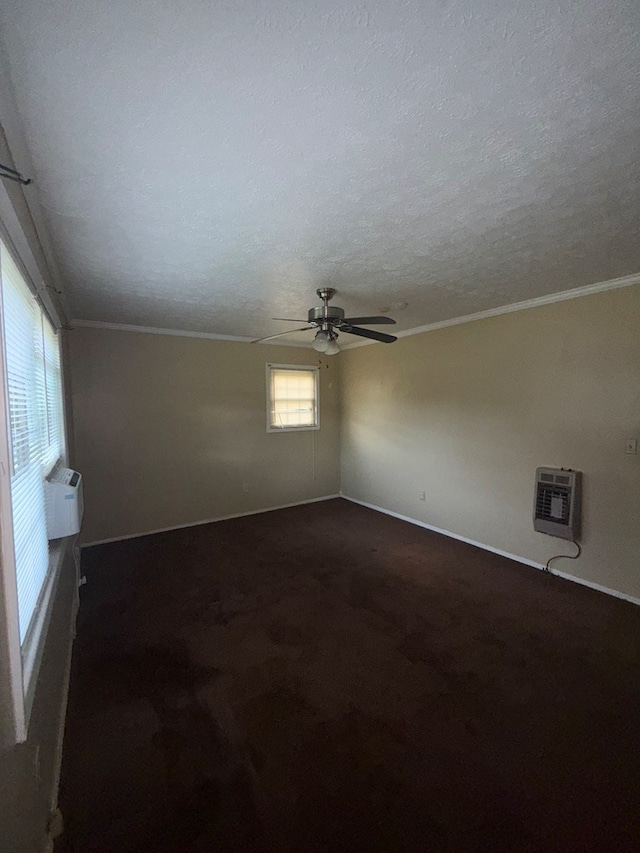 2303 Brown St, Dothan, AL 36303 - empty room featuring heating unit, ceiling fan, baseboards, a textured ceiling, and dark carpet