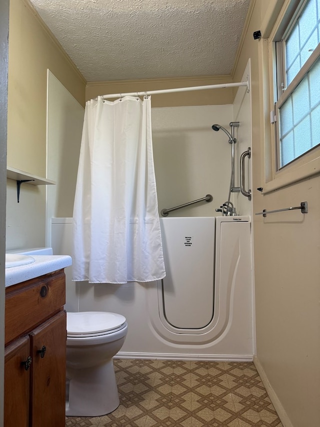 2303 Brown St, Dothan, AL 36303 - bathroom featuring tile patterned floors, a textured ceiling, toilet, vanity, and a shower