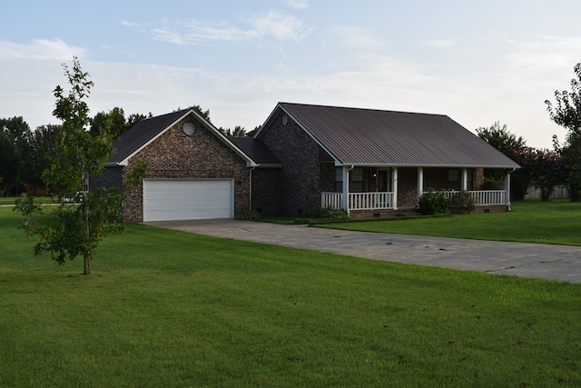 view of front of home featuring a garage, covered porch, and a front yard