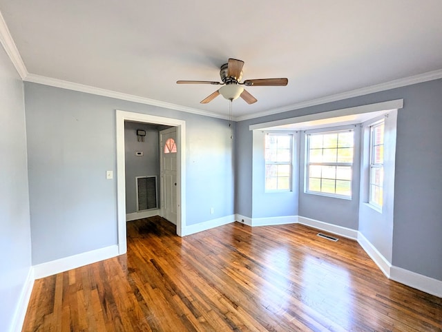 spare room featuring ceiling fan, crown molding, and dark wood-type flooring