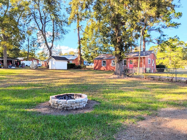 view of yard with a fire pit