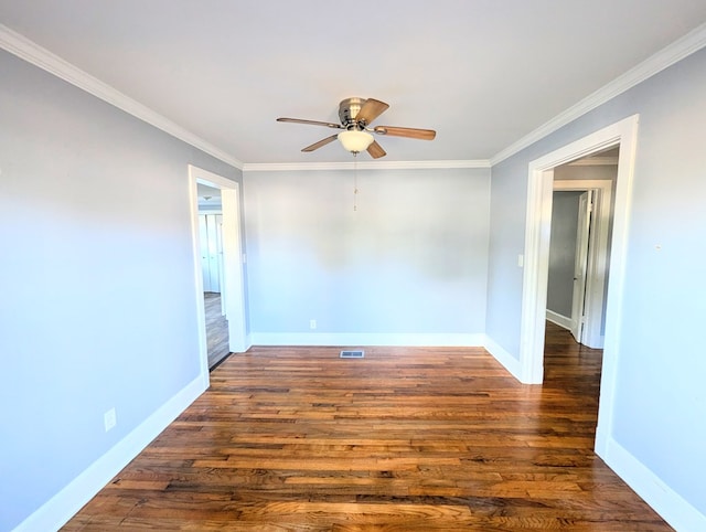 empty room with ceiling fan, dark hardwood / wood-style flooring, and ornamental molding