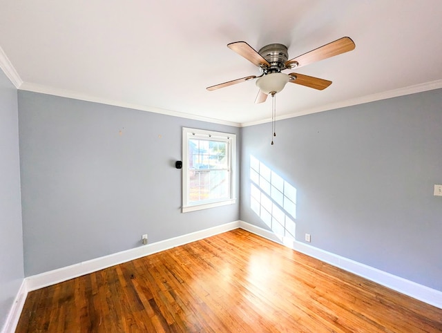 spare room featuring light wood-type flooring, ceiling fan, and crown molding