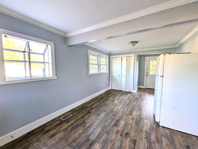 unfurnished bedroom with white fridge, crown molding, and multiple windows