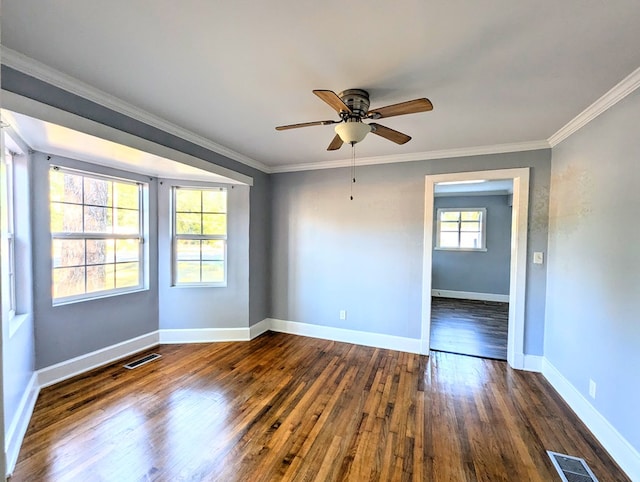 unfurnished room featuring ornamental molding, ceiling fan, and dark wood-type flooring