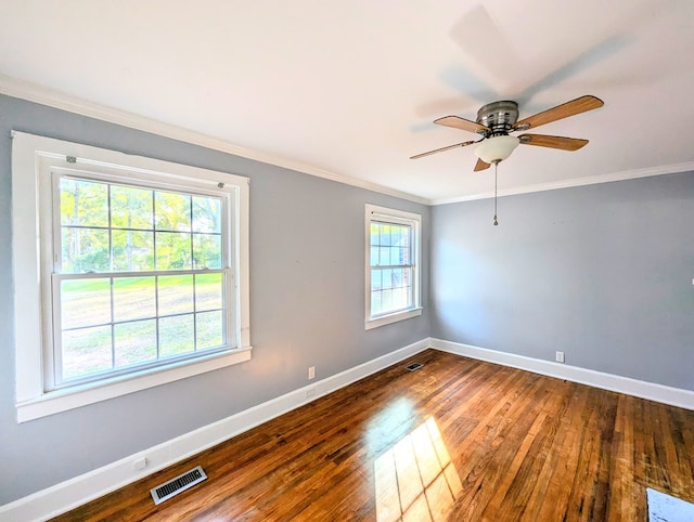 empty room featuring hardwood / wood-style floors, ceiling fan, crown molding, and a wealth of natural light