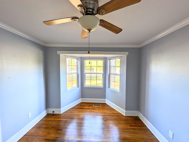 spare room with ceiling fan, ornamental molding, and dark wood-type flooring