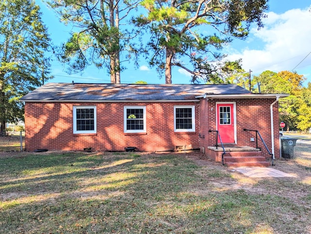 rear view of house featuring a yard