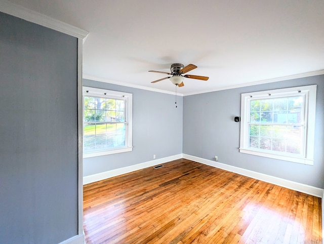 empty room featuring crown molding, hardwood / wood-style floors, and ceiling fan