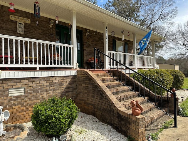 entrance to property featuring covered porch