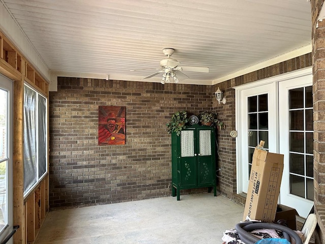 unfurnished sunroom featuring french doors and ceiling fan