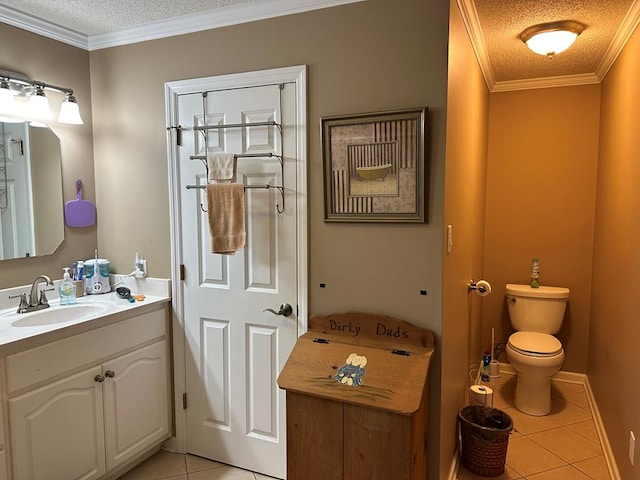 bathroom with tile patterned floors, ornamental molding, vanity, a textured ceiling, and toilet