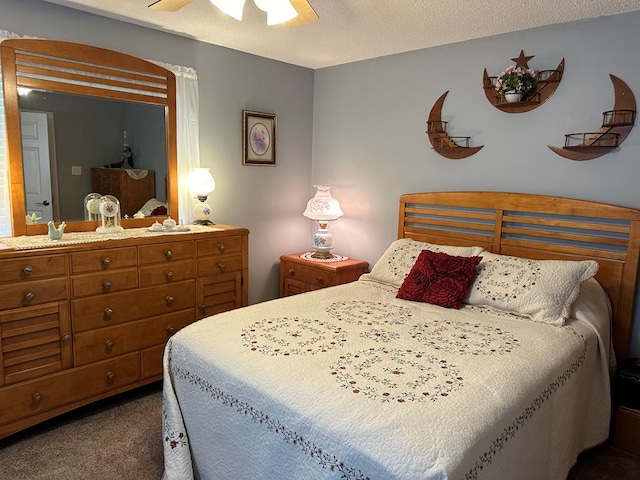 bedroom featuring dark colored carpet, ceiling fan, and a textured ceiling