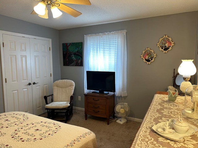 carpeted bedroom featuring a textured ceiling, a closet, and ceiling fan