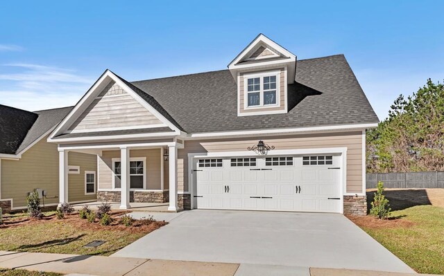 craftsman-style house with a porch and a garage