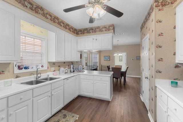 kitchen featuring kitchen peninsula, dark hardwood / wood-style flooring, white dishwasher, pendant lighting, and white cabinetry