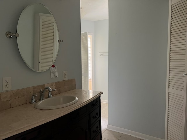 bathroom featuring tile patterned flooring, vanity, and baseboards